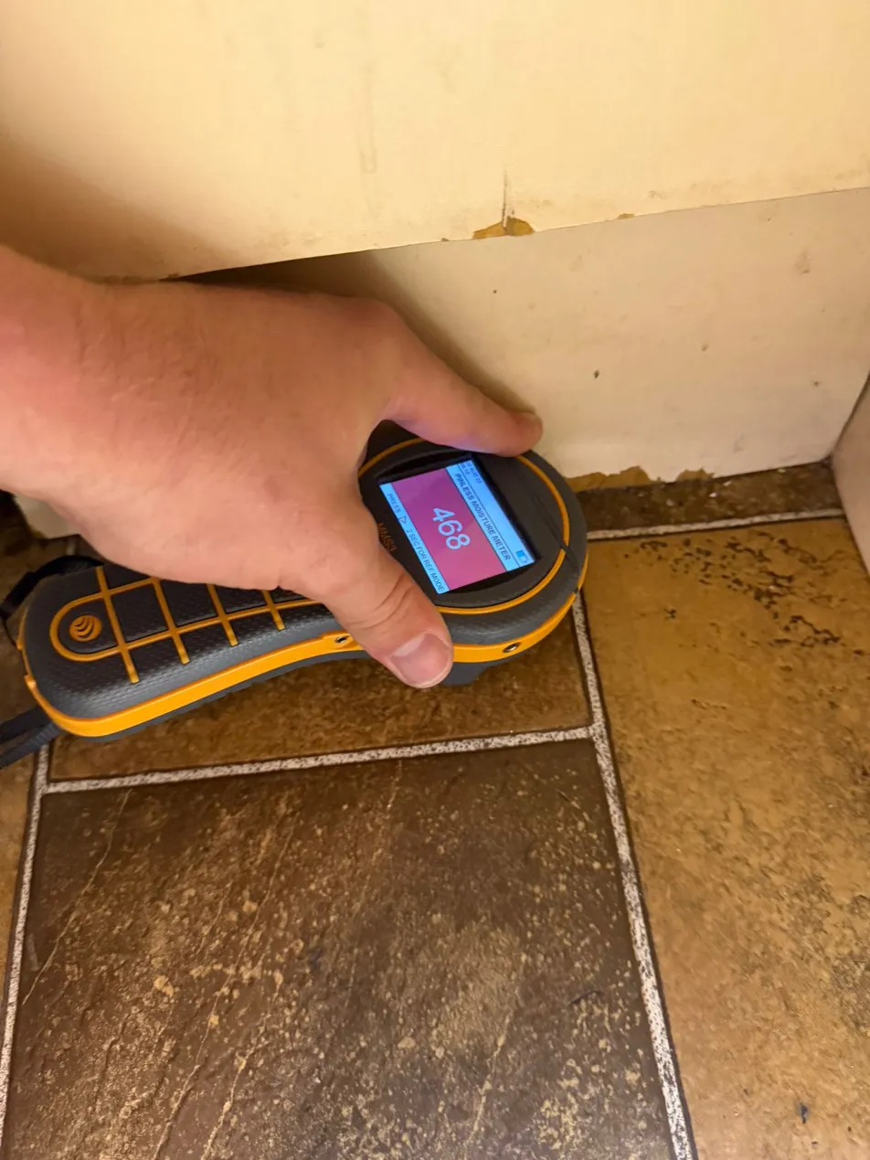 Pinless moisture meter at wall and floor junction
